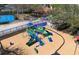 Aerial shot of a colorful playground with slides and climbing structures, set on a wood chip base at 6153 Metrowest Blvd # 103, Orlando, FL 32835