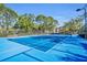 Community tennis court with lush surroundings at 6153 Metrowest Blvd # 103, Orlando, FL 32835