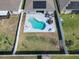Aerial view showcasing a sparkling pool, well-maintained backyard, and secure white fencing at 649 Meadow Pointe Dr, Haines City, FL 33844