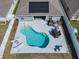 Aerial view of a private backyard featuring a sparkling pool, lounge chairs, and an outdoor dining area at 649 Meadow Pointe Dr, Haines City, FL 33844
