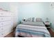 Light blue bedroom with dressers on each side of the bed, carpet, and closet at 649 Meadow Pointe Dr, Haines City, FL 33844