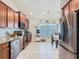 Well-lit kitchen featuring stainless steel appliances, tile backsplash, and tile flooring at 649 Meadow Pointe Dr, Haines City, FL 33844