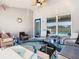 Comfortable screened lanai with various seating options, ceiling fan, and stylish decor at 649 Meadow Pointe Dr, Haines City, FL 33844
