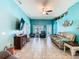 Open living room with a ceiling fan and a turquoise accent wall at 649 Meadow Pointe Dr, Haines City, FL 33844