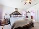 The spacious main bedroom features a large bed, dresser, and access to the ensuite bathroom at 649 Meadow Pointe Dr, Haines City, FL 33844