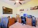 Bright home office featuring vaulted ceilings, ceiling fan, and a flat screen TV at 649 Meadow Pointe Dr, Haines City, FL 33844