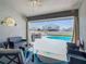 Comfortable outdoor patio with seating, retractable door, and an outdoor pool and deck at 649 Meadow Pointe Dr, Haines City, FL 33844