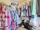 Large walk-in closet with an organized hanging rack for clothes and multiple shoe racks at 649 Meadow Pointe Dr, Haines City, FL 33844