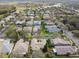 Gorgeous aerial view of a residential neighborhood featuring manicured lawns and mature trees near a serene lake at 651 Highlands Hammock Dr, Poinciana, FL 34759