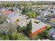 Aerial view of a well-landscaped single Gathering home featuring mature trees and a beige roof at 651 Highlands Hammock Dr, Poinciana, FL 34759