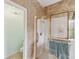 Bright bathroom featuring a tiled shower with glass door at 651 Highlands Hammock Dr, Poinciana, FL 34759