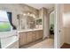 Bathroom featuring a double vanity, walk in closet, and arched entrance at 651 Highlands Hammock Dr, Poinciana, FL 34759