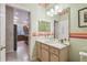 Bathroom featuring a vanity with a sink and a view into the kitchen at 651 Highlands Hammock Dr, Poinciana, FL 34759