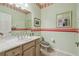 Stylish bathroom with a vanity, sink, and a mirror at 651 Highlands Hammock Dr, Poinciana, FL 34759