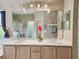 Bathroom featuring a double vanity, large mirror, and modern lighting at 651 Highlands Hammock Dr, Poinciana, FL 34759