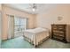 Bright bedroom with a ceiling fan and a large dresser at 651 Highlands Hammock Dr, Poinciana, FL 34759