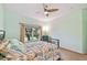 Bright and airy bedroom with large window, ceiling fan, soft carpet, and a decorative metal bed frame at 651 Highlands Hammock Dr, Poinciana, FL 34759