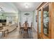 Open concept dining room with tile floors, a wood table and a decorative china cabinet at 651 Highlands Hammock Dr, Poinciana, FL 34759
