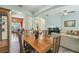 Bright dining room with a wood table, tile floors, and lots of natural light near the living area at 651 Highlands Hammock Dr, Poinciana, FL 34759