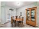 Cozy dining area with wood table, chairs, and a charming china cabinet at 651 Highlands Hammock Dr, Poinciana, FL 34759