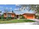 Charming single-story home with a well-maintained lawn and beautiful landscaping at 651 Highlands Hammock Dr, Poinciana, FL 34759