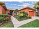 Beautifully landscaped front yard featuring lush green grass and a charming brick walkway at 651 Highlands Hammock Dr, Poinciana, FL 34759