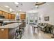 Open kitchen features granite counters, tile floors, stainless steel appliances, and an adjacent breakfast nook with a seating area at 651 Highlands Hammock Dr, Poinciana, FL 34759
