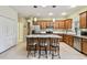 Bright kitchen with a large center island, stainless steel appliances, and a breakfast bar with stools at 651 Highlands Hammock Dr, Poinciana, FL 34759