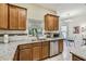 Well-appointed kitchen featuring granite counters, stainless steel appliances, and a bright, sunny window at 651 Highlands Hammock Dr, Poinciana, FL 34759