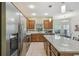 Open kitchen with a large island, stainless steel appliances, and natural light from windows at 651 Highlands Hammock Dr, Poinciana, FL 34759