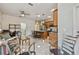 Open kitchen features granite counters, tile floors, stainless steel appliances, and an adjacent breakfast nook and seating area at 651 Highlands Hammock Dr, Poinciana, FL 34759