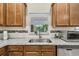 Kitchen view with granite countertops, stainless steel appliances, and tiled backsplash detail at 651 Highlands Hammock Dr, Poinciana, FL 34759