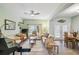 Bright living room featuring neutral furniture, ceiling fan, and a large window at 651 Highlands Hammock Dr, Poinciana, FL 34759
