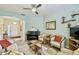 Inviting living room featuring comfortable seating, a piano, and ample natural light at 651 Highlands Hammock Dr, Poinciana, FL 34759