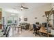 Bright living area has a ceiling fan, neutral paint, tile floor, and comfortable seating, with adjacent doorway to the bedroom at 651 Highlands Hammock Dr, Poinciana, FL 34759