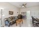 Bright living area has a ceiling fan, neutral paint, tile floor, and comfortable seating, with adjacent doorway to the bedroom at 651 Highlands Hammock Dr, Poinciana, FL 34759