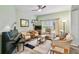 Cozy living room with comfortable seating, a piano, and a ceiling fan at 651 Highlands Hammock Dr, Poinciana, FL 34759