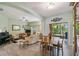 Bright, open living space combining living, dining, and outdoor access with modern furniture at 651 Highlands Hammock Dr, Poinciana, FL 34759