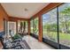 Screened lanai featuring comfortable seating and beautiful views of the landscaped yard with tropical trees and garden at 651 Highlands Hammock Dr, Poinciana, FL 34759