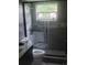 Bathroom featuring modern fixtures, a glass enclosed shower, and a window at 717 Michigan Ct # 2, St Cloud, FL 34769