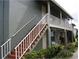 The exterior features stairs with white railings, and a covered porch at 717 Michigan Ct # 2, St Cloud, FL 34769