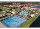 Aerial view showcases pool, tennis courts, and community amenities surrounded by lush landscaping and well-maintained homes at 8974 California Palm Rd, Kissimmee, FL 34747