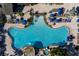 Detailed aerial view of the uniquely shaped community pool, including a hot tub and ample seating at 8974 California Palm Rd, Kissimmee, FL 34747