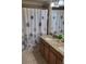 Neutral bathroom features granite counters, double sinks, modern shower/tub and decor at 8974 California Palm Rd, Kissimmee, FL 34747