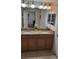 Beautiful bathroom features dual sinks with granite counters, decor and modern lighting at 8974 California Palm Rd, Kissimmee, FL 34747