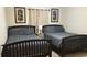 Bedroom featuring two twin beds with gray bedding, perfect for a restful night's sleep at 8974 California Palm Rd, Kissimmee, FL 34747