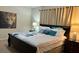 Bedroom features a king bed with decorative pillows, offering a relaxing retreat at 8974 California Palm Rd, Kissimmee, FL 34747