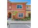 Inviting two-story townhome boasting a vibrant exterior, well-maintained landscaping, and convenient parking at 8974 California Palm Rd, Kissimmee, FL 34747