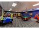 Spacious game room featuring billiards, air hockey, and arcade games for endless entertainment at 8974 California Palm Rd, Kissimmee, FL 34747