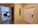 Hallway view featuring access to the bedroom and front door at 8974 California Palm Rd, Kissimmee, FL 34747